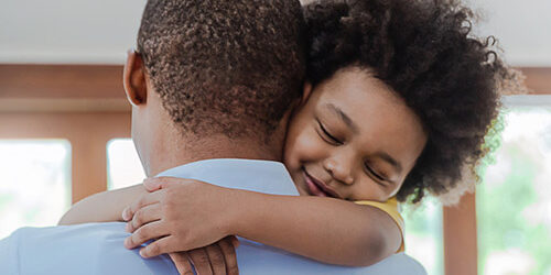 Father holding young daughter
